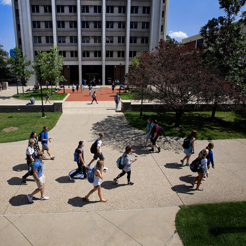 students are walking across campus