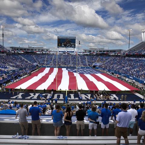photo of large U.S. flag at football stadium Murray 2018 game
