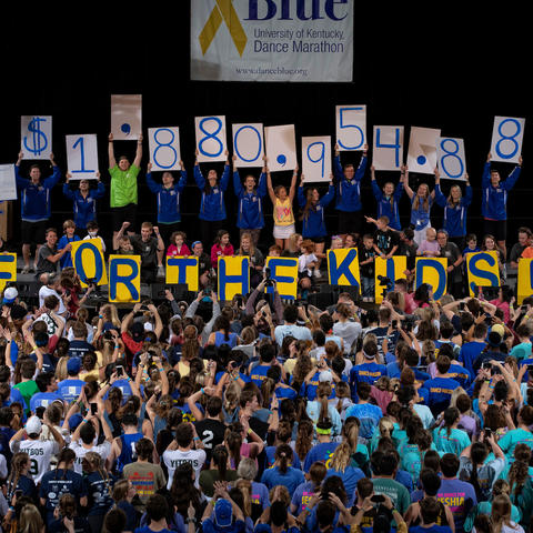 DanceBlue participants holding up total amount of money raised
