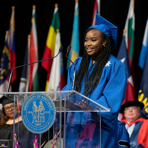 Graduate speaking at podium