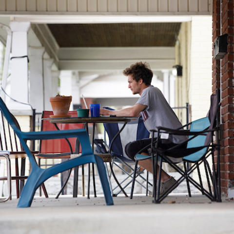 Photo of student working on porch