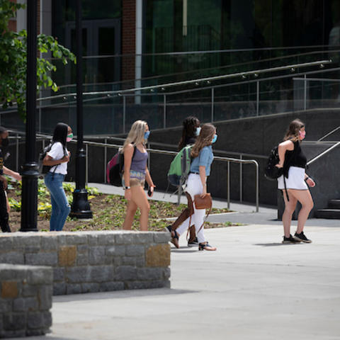 Photo of students wearing masks walking through campus
