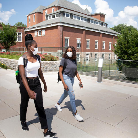 photo of two students walking on campus