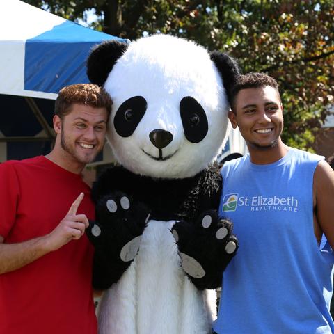 photo of 2 male students at Confucius Institute Day with panda