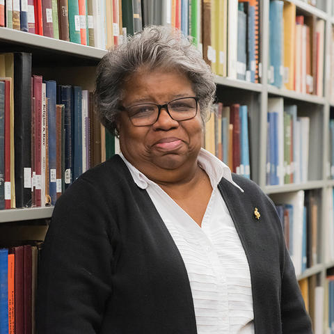 Sharyn Mitchell pictured standing between stacks at Berea College Library