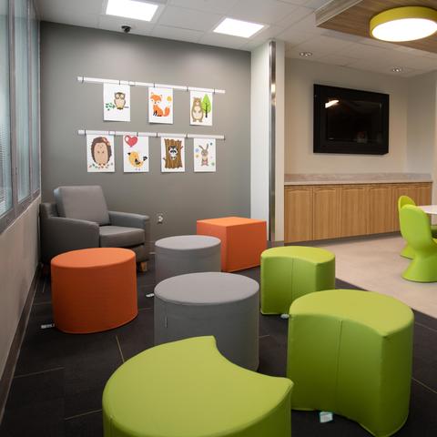 Image of group activity room with brightly colored furniture and child-friendly decorations