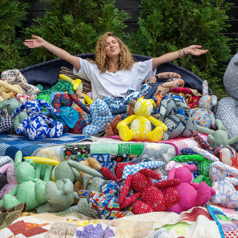 image of Caroline surrounded by the toy bunnies made for babies in the NICU
