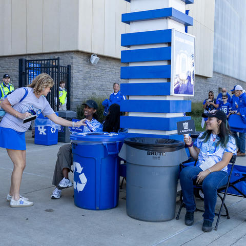 Big Blue Recycling Crew members helping fans at Kroger Field to dispose of their waste. Photo by Bree Walton