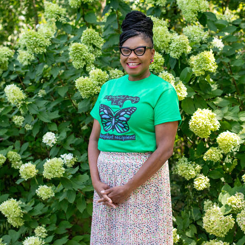 Image of Ashley Holt standing in front of hydrangeas 