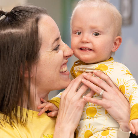 Image of Addi being held by her mother Hannah