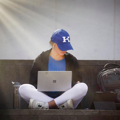 A student works on a laptop.