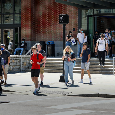 students walking across the cross walk in front of the student center toward memorial coliseum