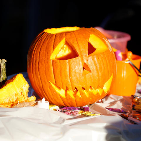 Photo of a Jack-O-Lantern Surrounded by Candy