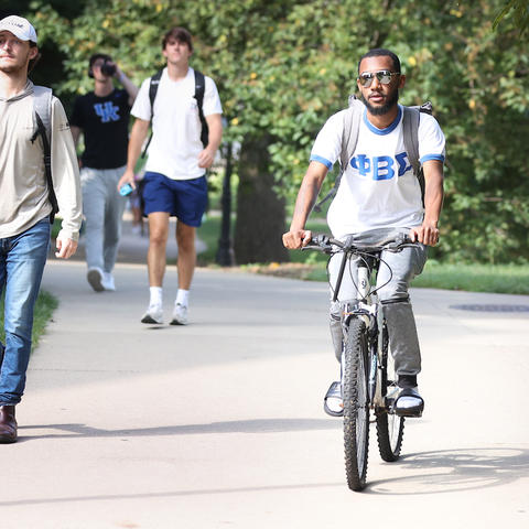 Someone riding a bike on campus. 