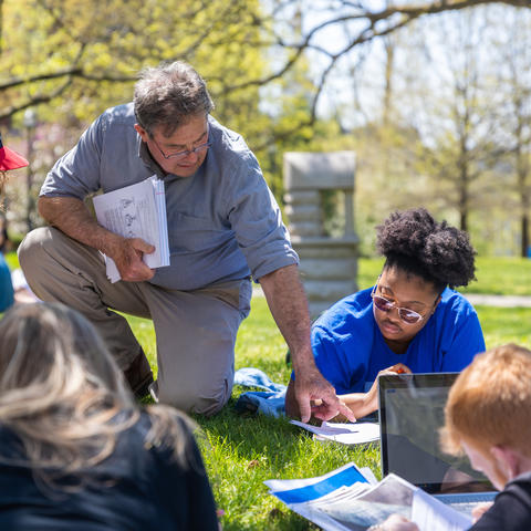 This is a photo of a faculty member teaching students outside on the UK campus. 