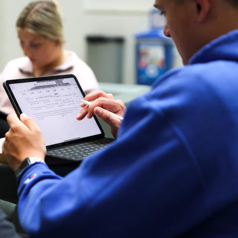 Students studying on an iPad. 