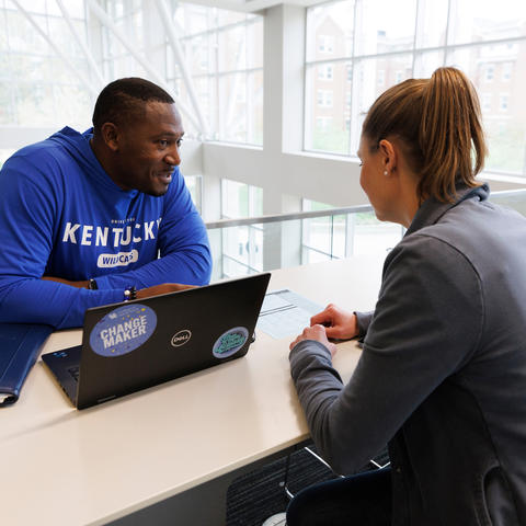 This is a photo of a University of Kentucky staff member advising a student.