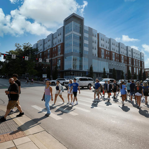 students walking across a crosswalk on campus