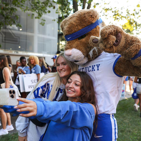Students taking a selfie with the Wildcat. 