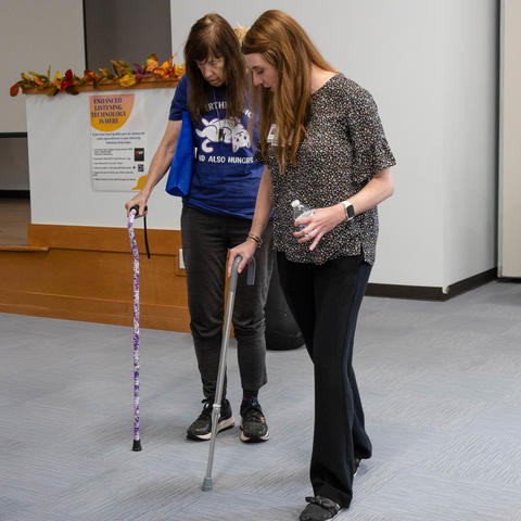 Two women holding canes