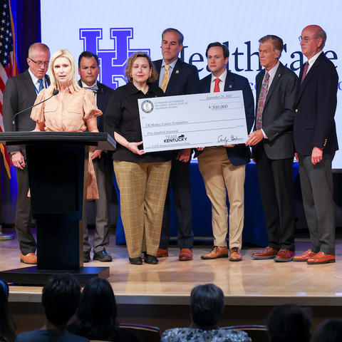 Image of physicians, legislators and advocates with a check to support cancer patients and families