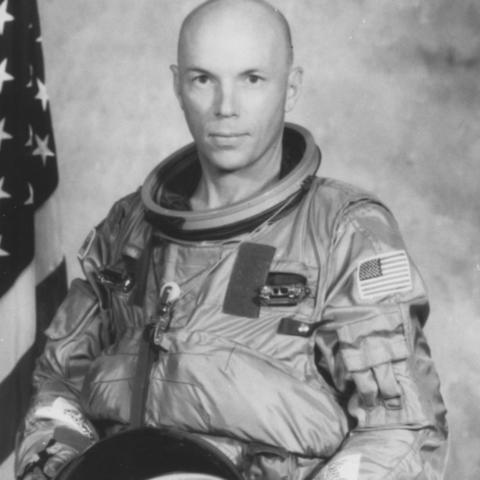 black and white astronaut Story Musgrave in flight suit