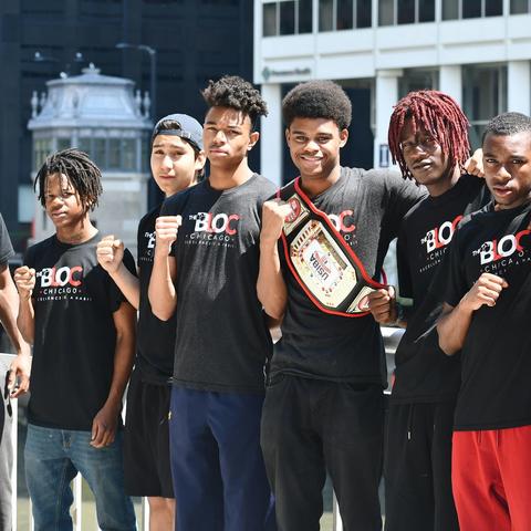 Photo of Jamyle Cannon with students from The Bloc