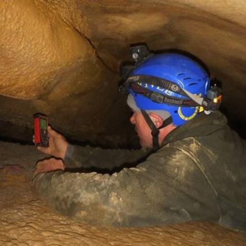 Bruce Isaacs, who discovered Kentucky’s 5,000th cave, explores another underground passage.