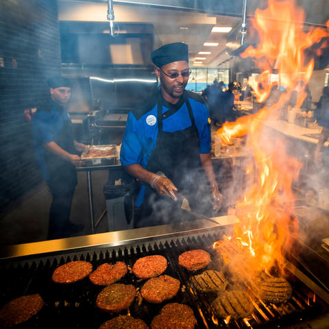 photo of chef grilling hamburgers in Champions Kitchen