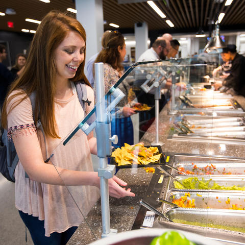 photo of young woman at a food buffet