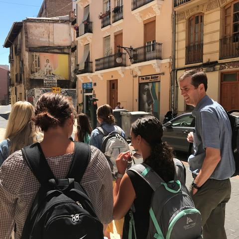 UK Deputy General Counsel Cliff Iler walks with Education Abroad students in city in Spain