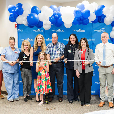 Image of group of people cutting a ribbon