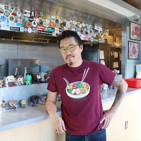 photo of Dan Wu in front of his kitchen at Atomic Ramen in The Barn at The Summit