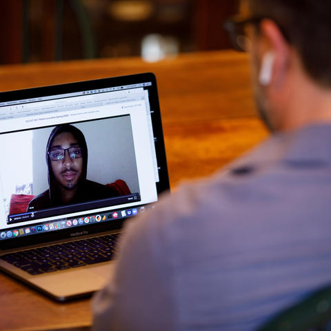 photo of faculty member talking to student via Zoom