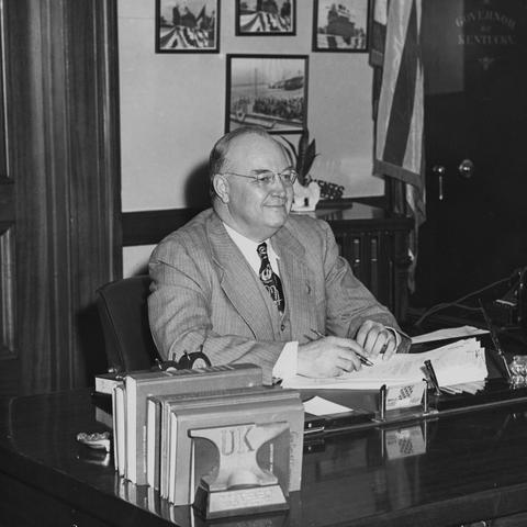 black and white photo of Governor Earle C. Clements seated at desk