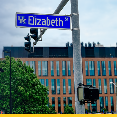 Graphic announcing a road name update: Press Avenue is now Elizabeth Street. A new Elizabeth Street sign appears near a traffic signal on the University of Kentucky campus.