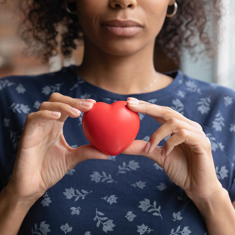 image of woman holding red heart