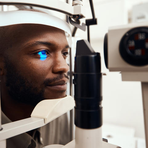 photo of man receiving eye test with machine