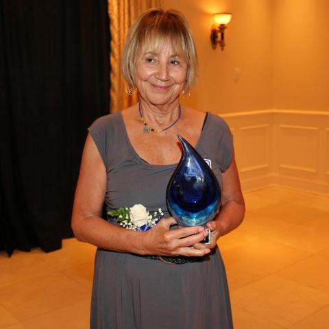 photo of Kay Hoffman with College of Social Work Hall of Fame award