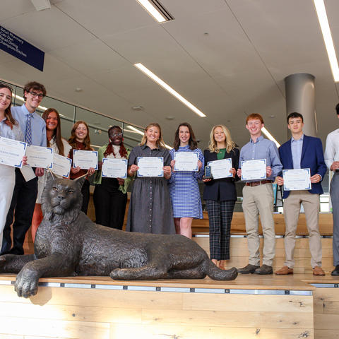 People standing with awards. 