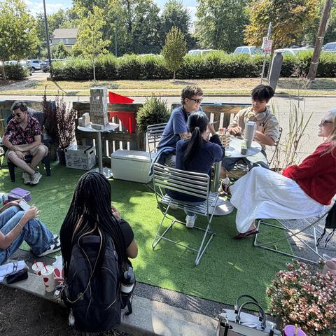 The organizers repurposed chairs and tables from the building and incorporated plants lent by Wilson Plant Company to bring the small space to life.  