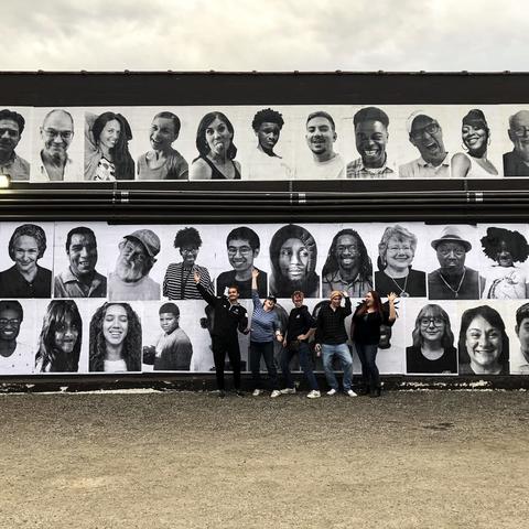 students from guerrilla art class with InsideOutLex installation on Carson's wall