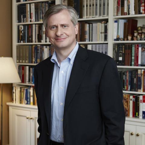 photo of Jon Meacham in front of bookcase