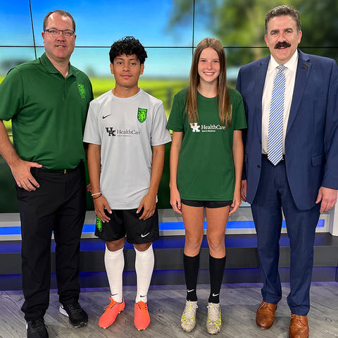 student soccer players standing together on the news