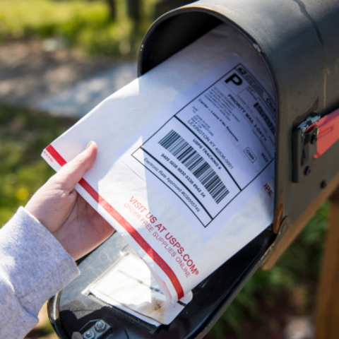 USPS package being pulled out of a mailbox