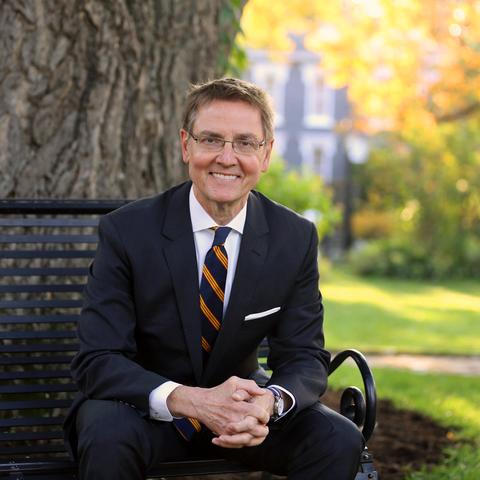 photo of Jim Gray seated on bench