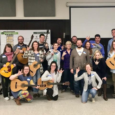 photo of participants in Modern Band Workshop holding guitars