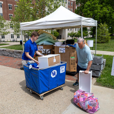 Ryan Lark, zero-wast specialist in Facilities Management, helped a parent move donated items during move-out.