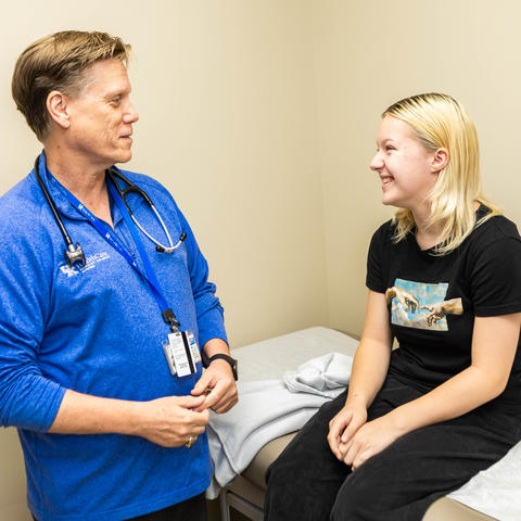 image of Annastasia Tipton with Louis Bezold, M.D. in an exam room