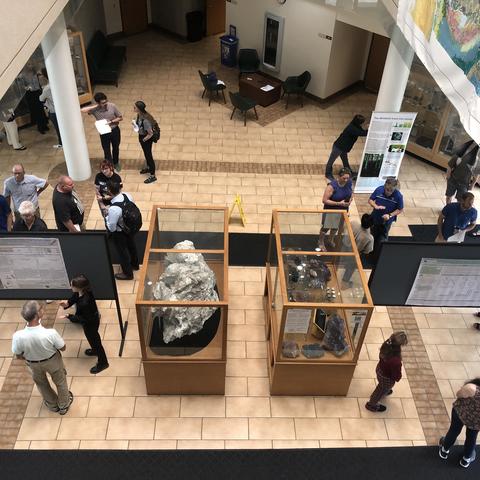 Students, faculty, staff and guests gather in the MMRB atrium to view research posters and chat with interns during the 2024 Potter Internship Showcase. 